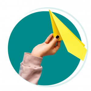 "Image of a hand holding a paper plane, symbolizing immigration and the journey to a new destination